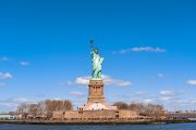 The Statue of Liberty under the blue sky background, Lower Manhattan, New York City,